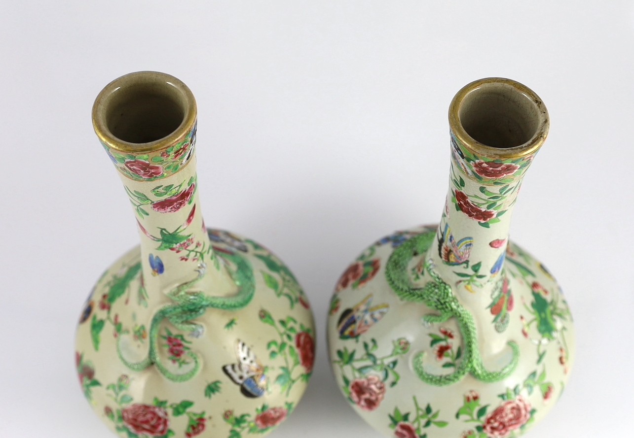 A pair of Chinese enamelled porcelain crackle glaze bottle vases, mid 19th century, 33cm high, chips to feet